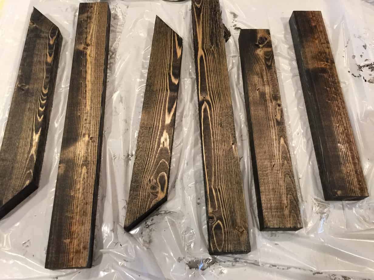 Stained wood pieces to make the wall mount for farmhouse pendant lights.