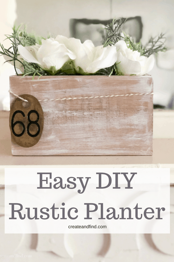 Pinterest graphic with text that reads \"Easy DIY Rustic Planter\" and white flowers in a whitewashed wooden box.